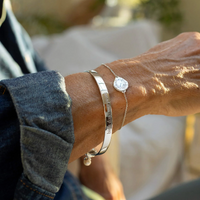 CLAUDIA BRADBY X MIDLIFECHIC MANTRA ROUND BANGLE WITH SINGLE PEARL CHARM